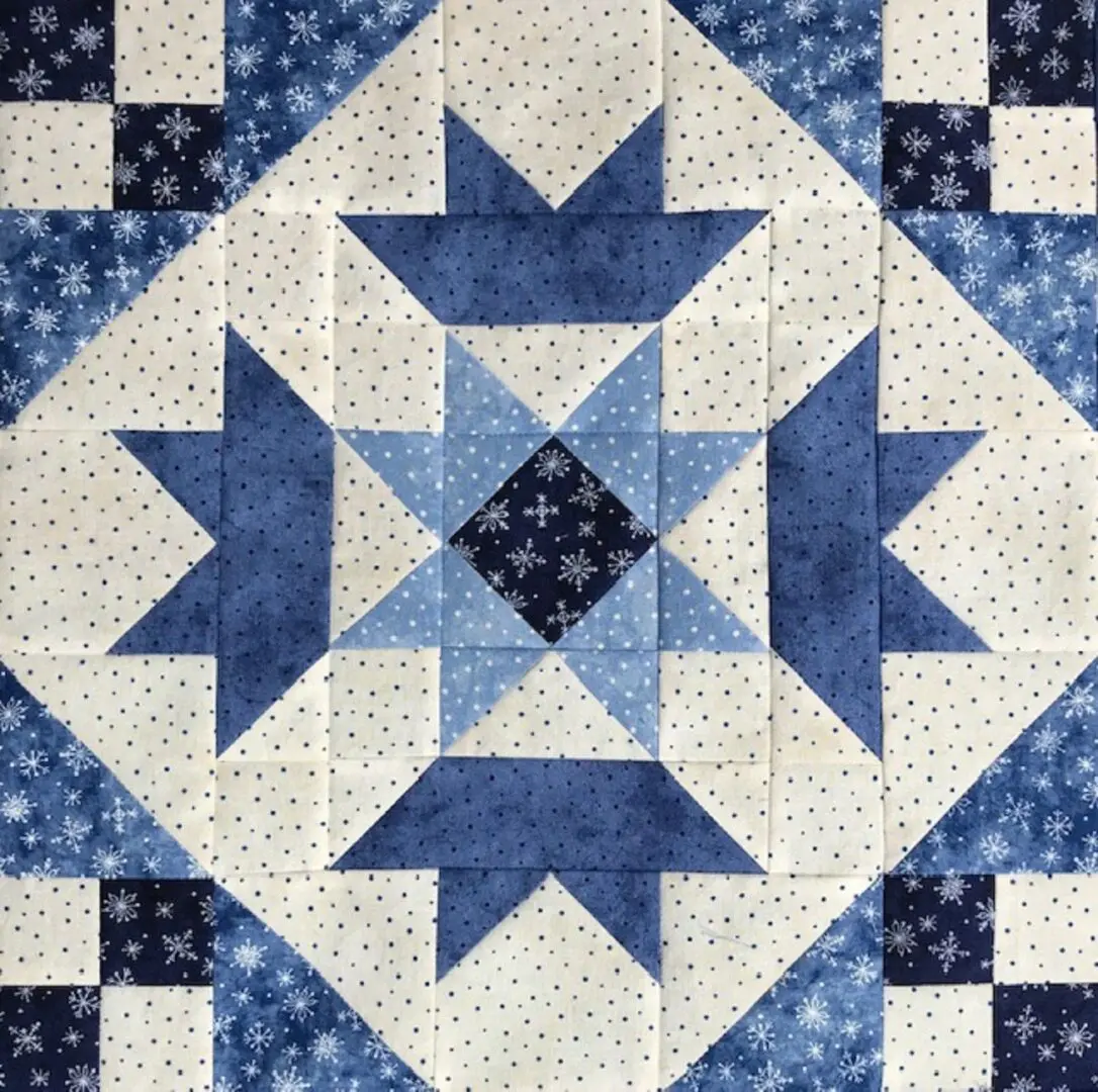 A blue and white quilt with stars on it.