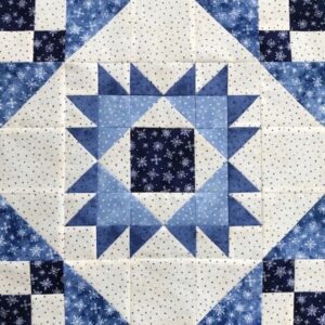 A blue and white quilt with a square pattern.