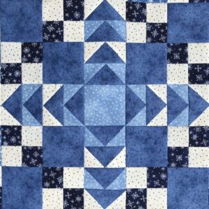 A blue quilt with white and black squares