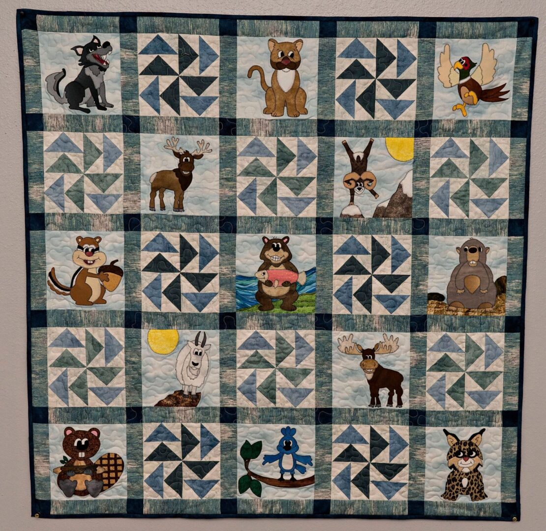 A quilt with animals and birds on it.