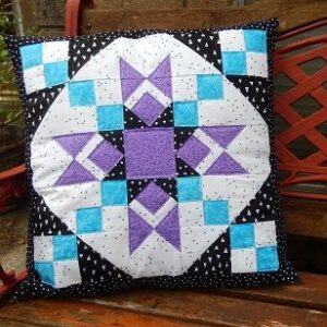 A pillow with a quilt pattern on it.