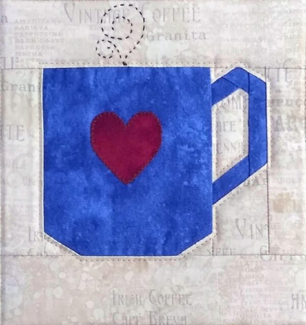 A blue coffee cup with a heart on it.