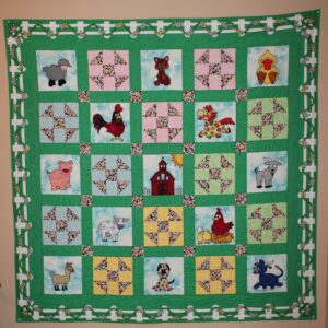 A green quilt with animals on it