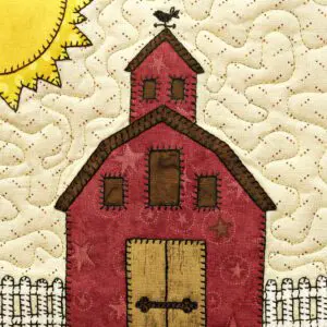 A red barn with a bird on top of it.
