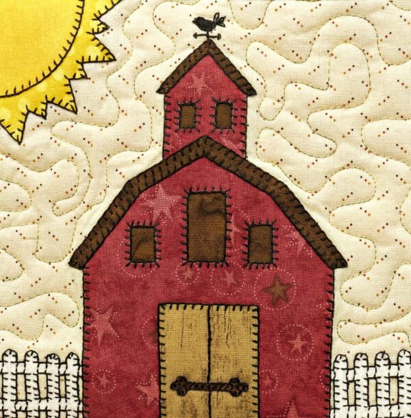 A red barn with a bird on top of it.