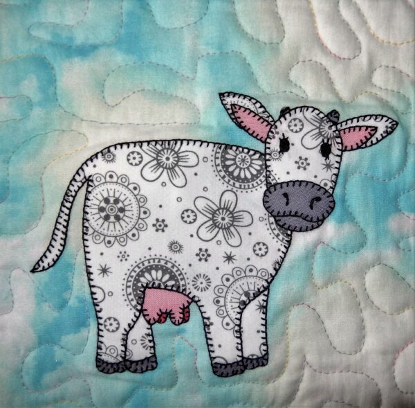 A cow is drawn with flowers on it's body.