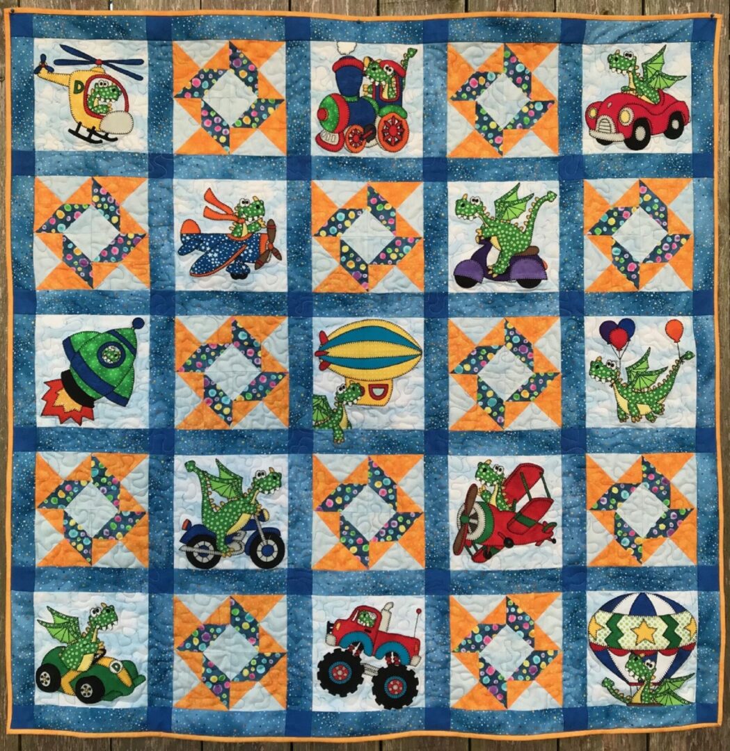 A quilt with various vehicles on it.