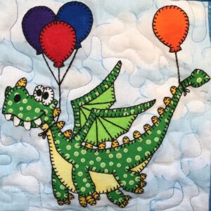 A green dragon with balloons flying through the air.