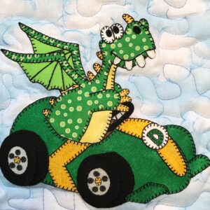 A green dragon is sitting on the hood of a car.