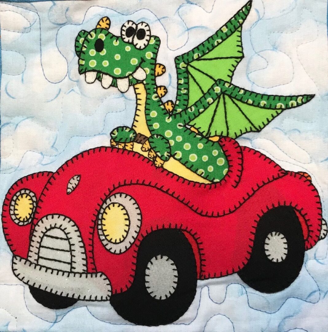 A dragon is sitting in the back of a red car.