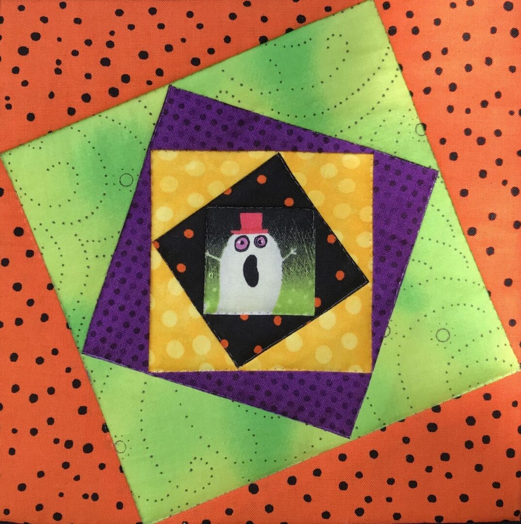 A quilt block with an image of a ghost on it.