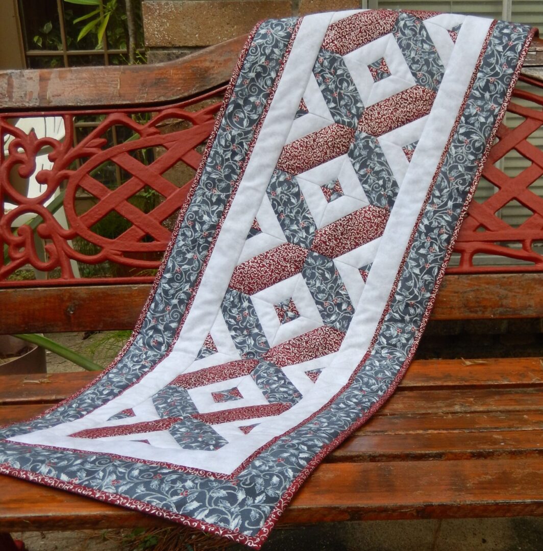 A table runner is sitting on the bench.