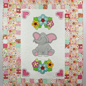A quilt with an elephant and flowers on it.