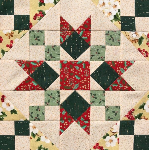 A quilt with a star and squares in the center.