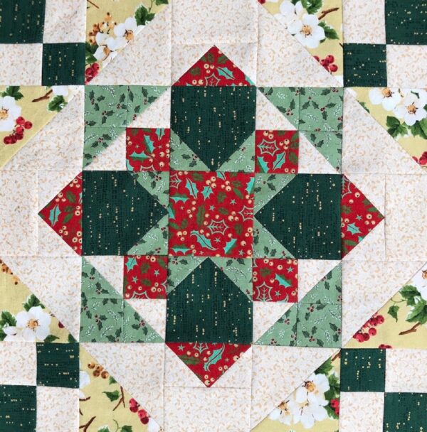 A quilt with green and red squares on it.