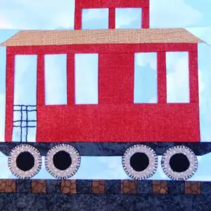 A red caboose is on the tracks.