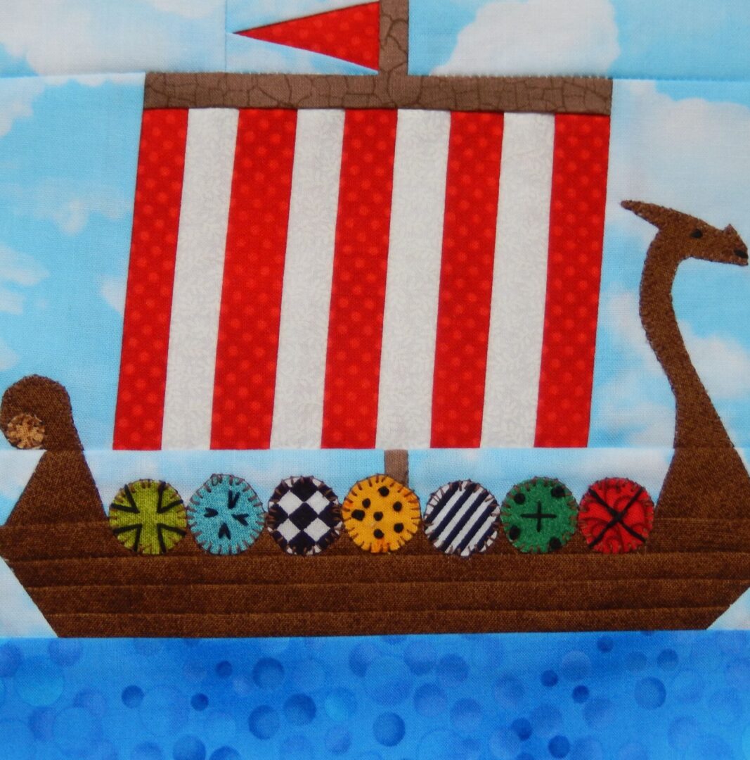 A red and white striped boat with a wooden sail.
