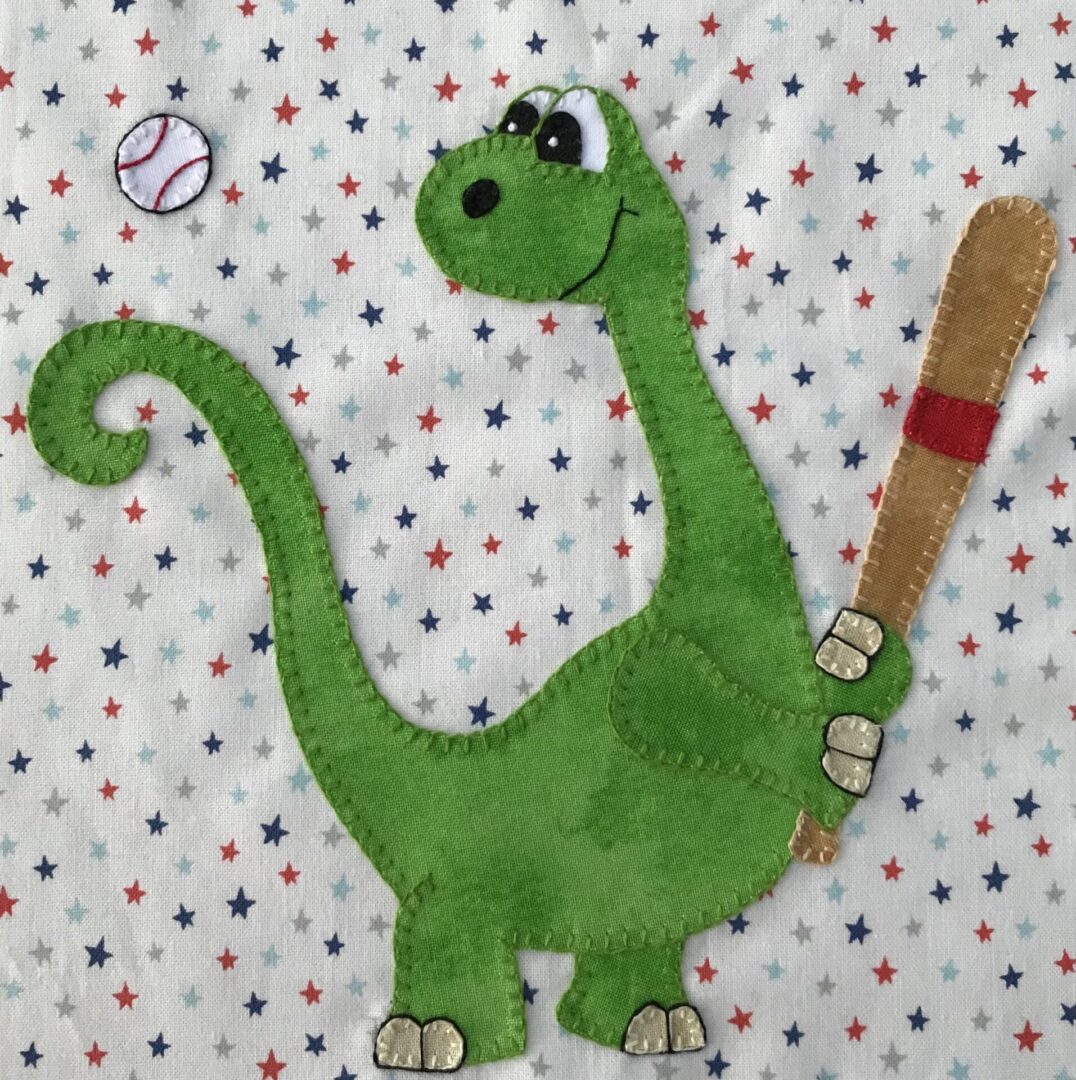 A green dinosaur holding a baseball bat and ball.