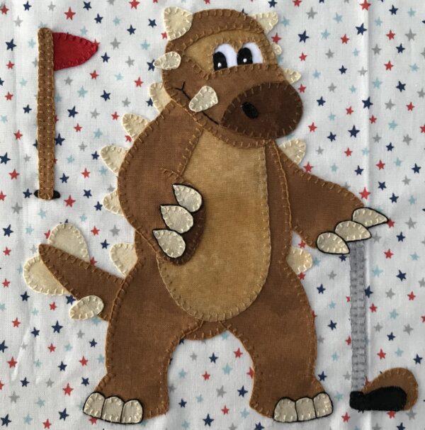 A brown stuffed animal holding a golf club.