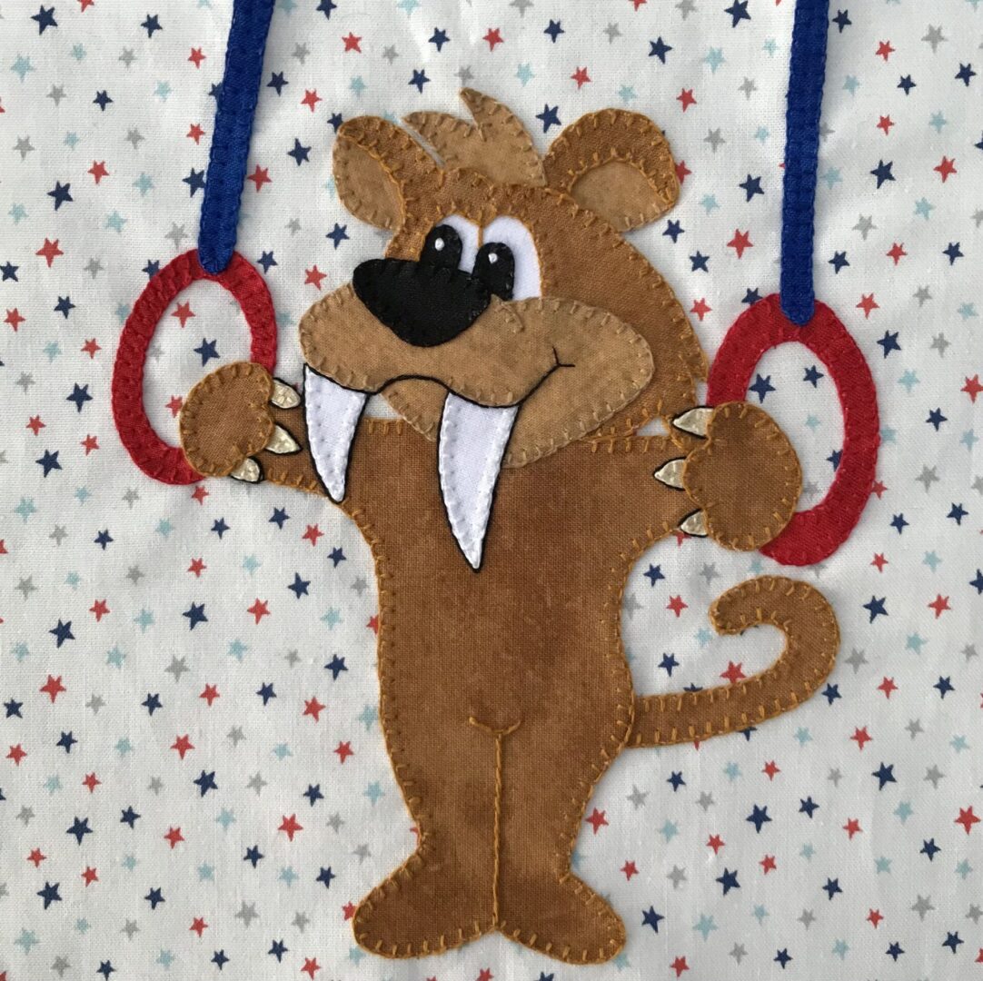 A stuffed animal hanging from two rings.