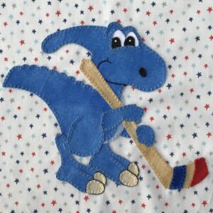 A blue dinosaur holding a stick in its mouth.