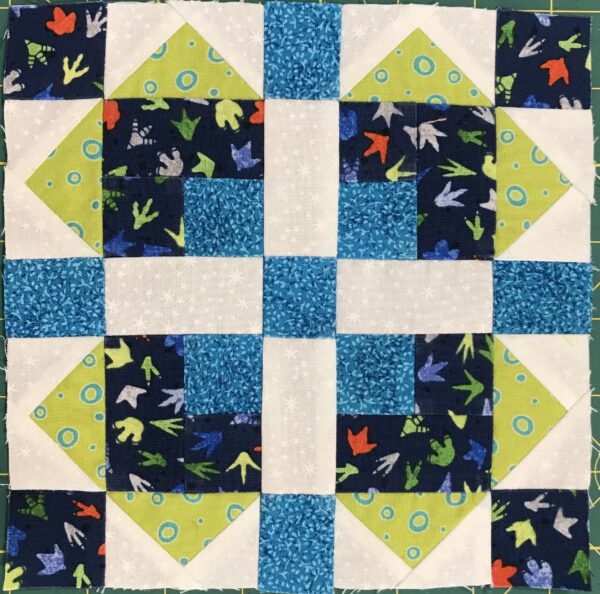 A quilt with blue and green squares on it.