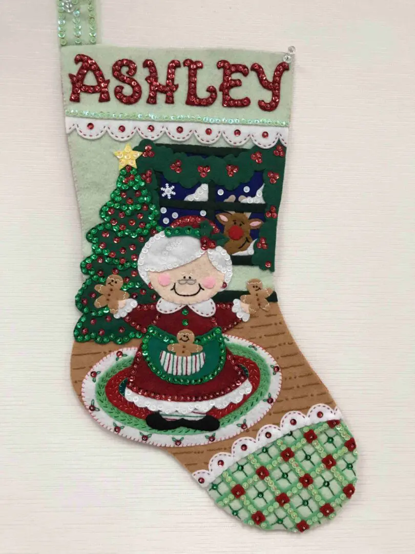 A christmas stocking with an image of mrs. Claus and gingerbread cookies