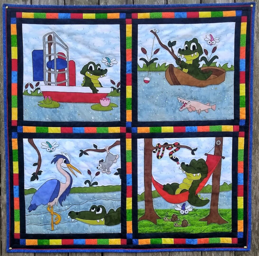 A quilt with four different pictures of animals.