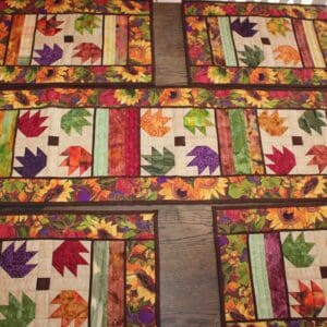 A table runner with colorful leaves on it.