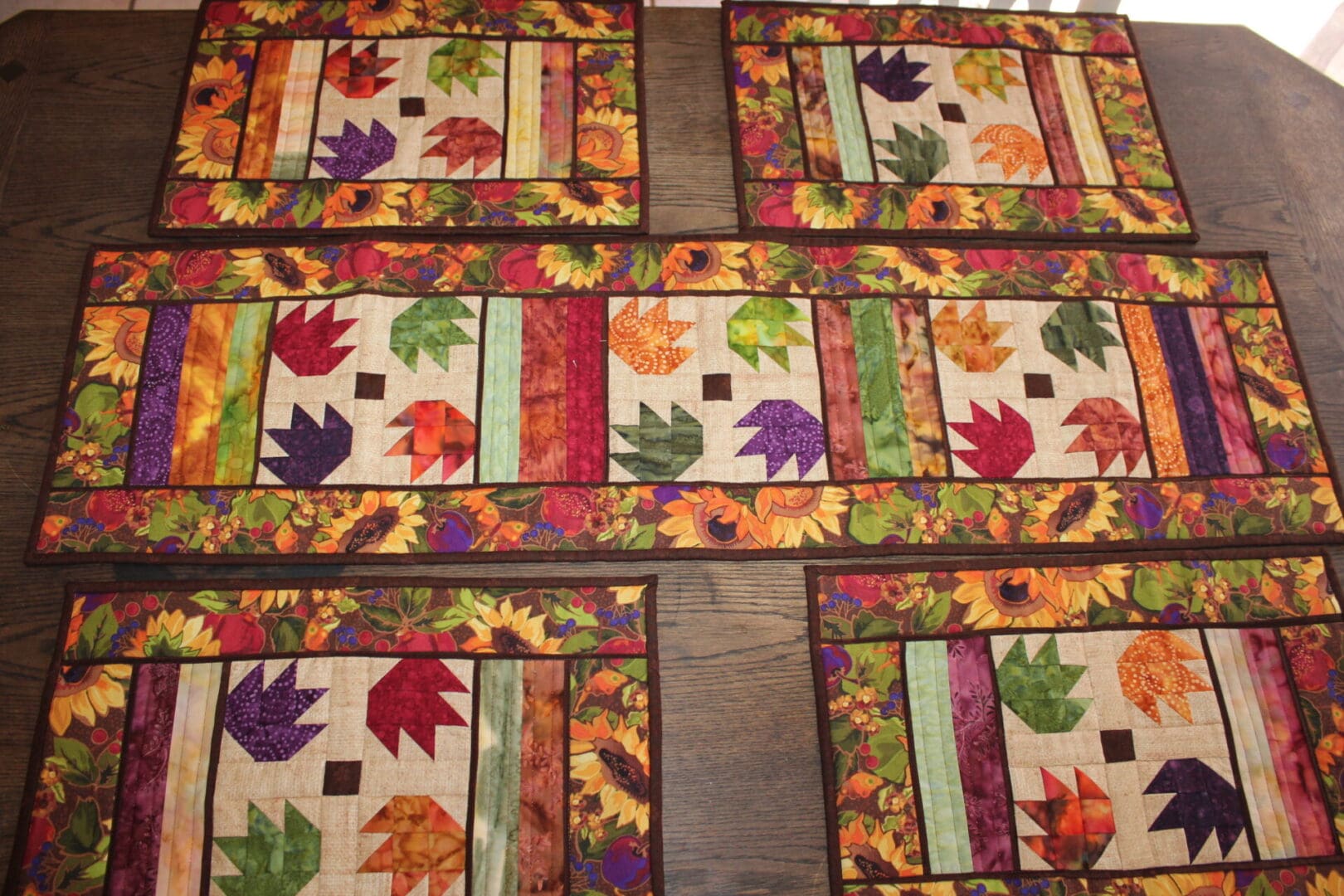 A table runner with colorful leaves on it.