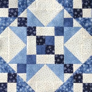 A blue and white quilt with stars on it.