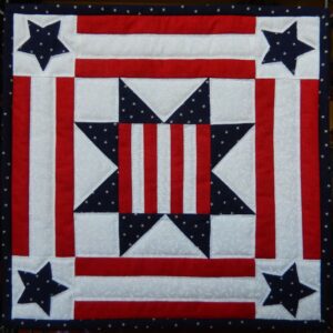 A patriotic quilt with stars and stripes.