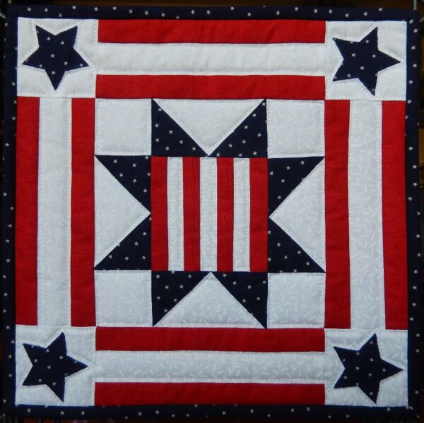 A patriotic quilt with stars and stripes.