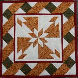 A quilt with a star on it and some other shapes