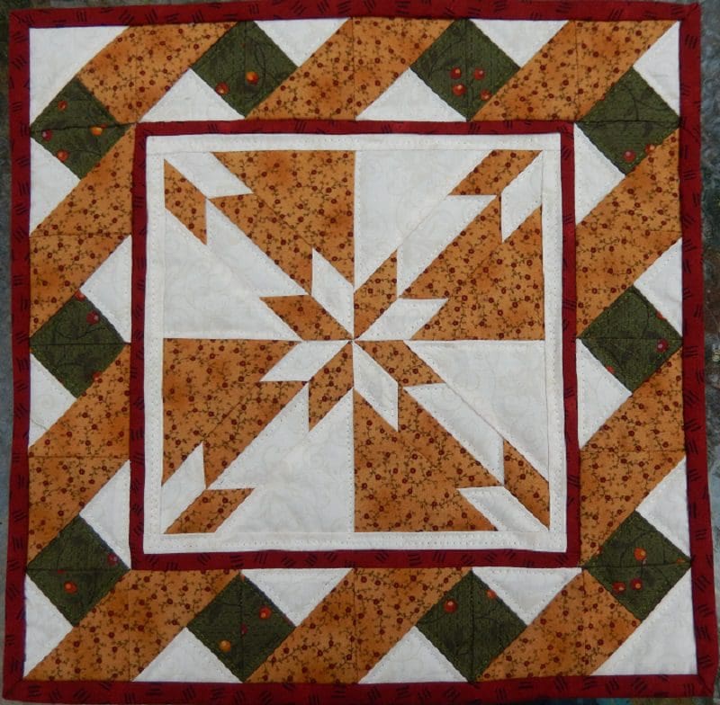 A quilt with a star on it and some other shapes