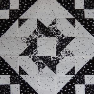 A black and white quilt with stars on it