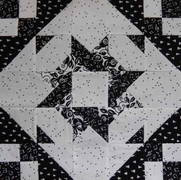 A black and white quilt with stars on it