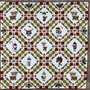A quilt with santa claus and reindeer on it.