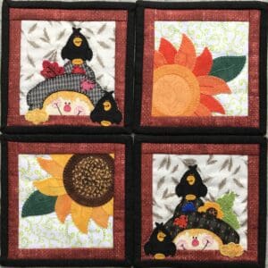 A set of four coasters with sunflowers and bears.
