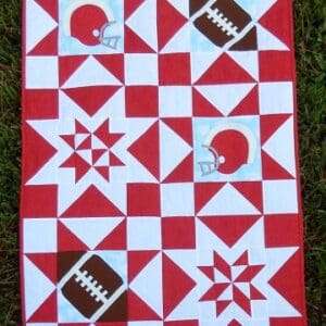 A red and white quilt with football designs.