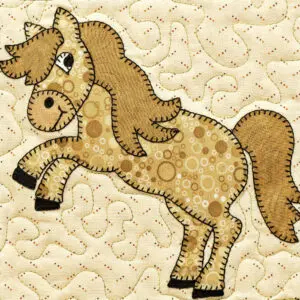A horse is made of fabric and has spots.