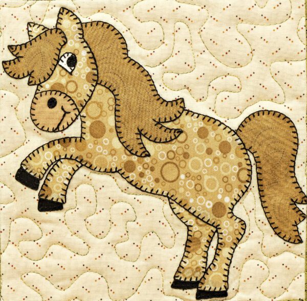 A horse is made of fabric and has spots.