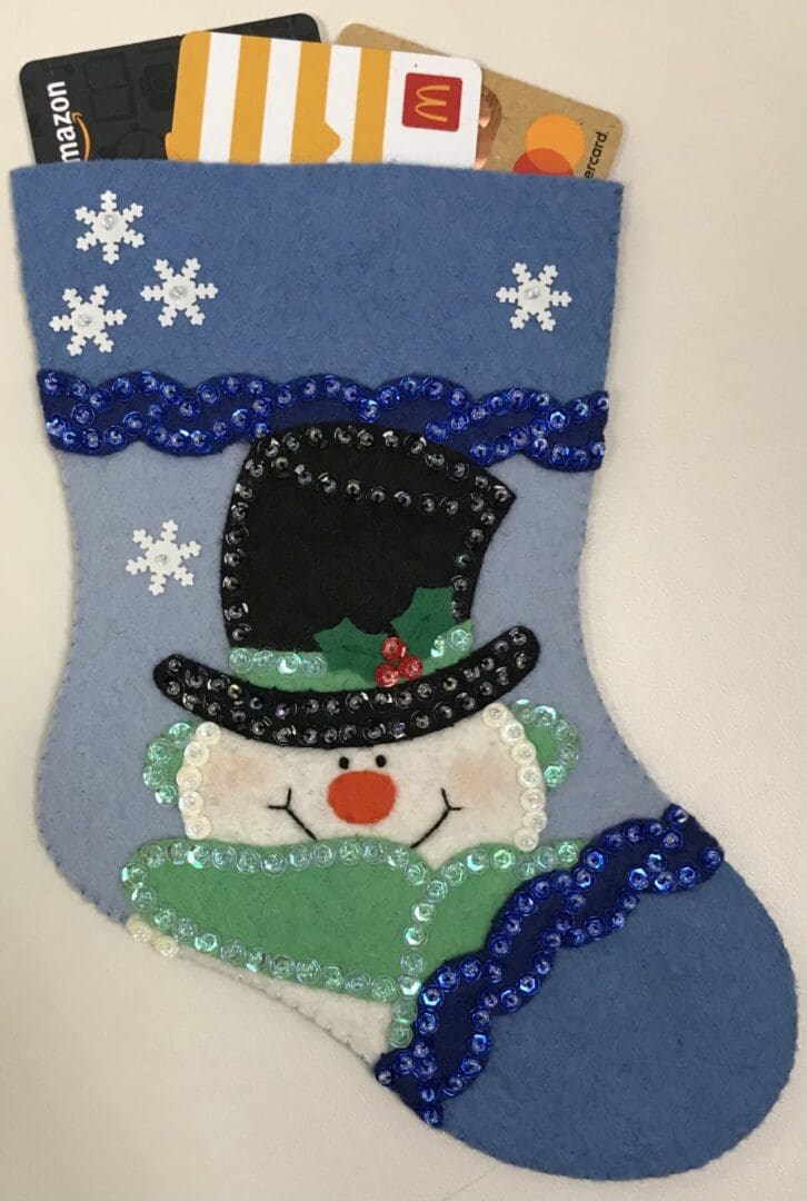 A blue and white christmas stocking with a snowman on it.