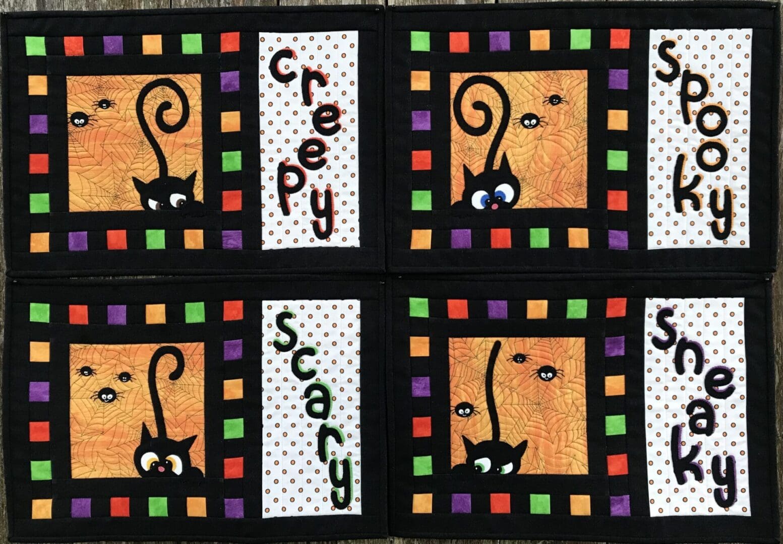 A close up of the four squares with cats on them