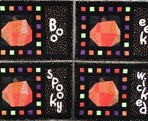 A group of four quilted squares with different designs.