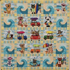 A quilt with bears and cars on it.