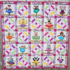 A quilt with different colored squares and pictures of cats.