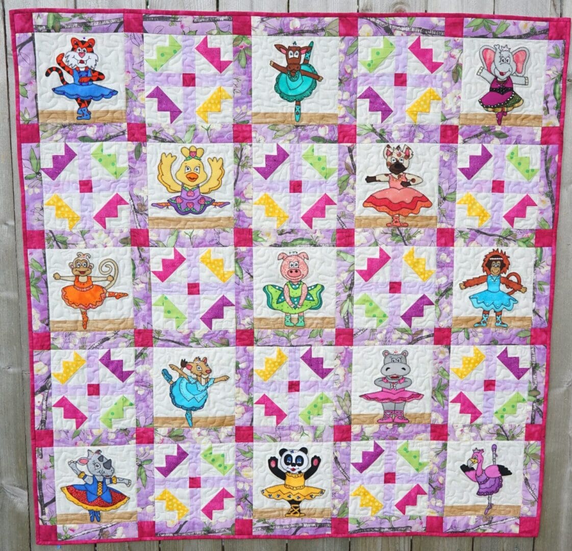 A quilt with different colored squares and pictures of cats.
