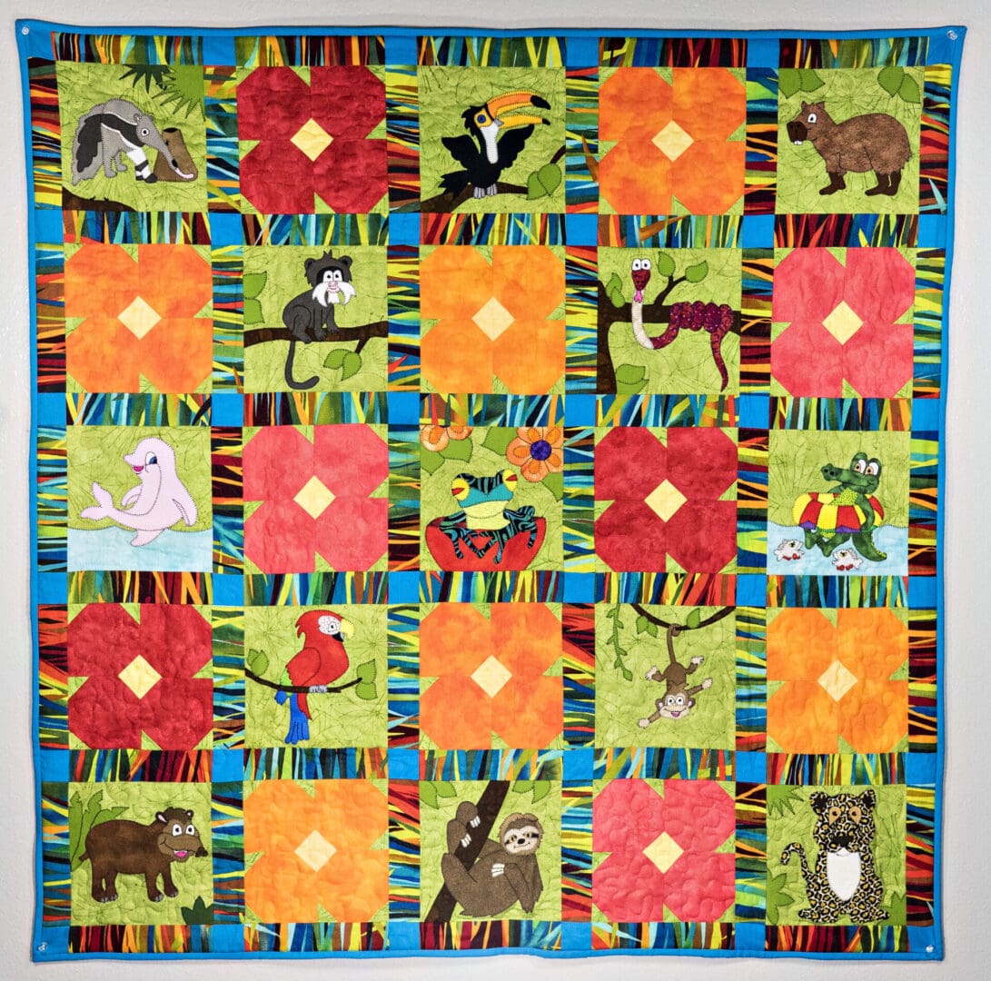 A quilt with animals and flowers on it.