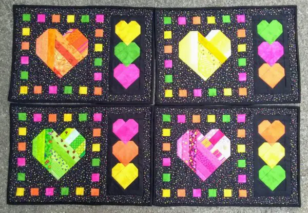 A set of four heart coasters with different colors.